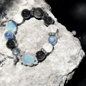 Healing crystal bracelet with aquamarine and moonstone on stone surface