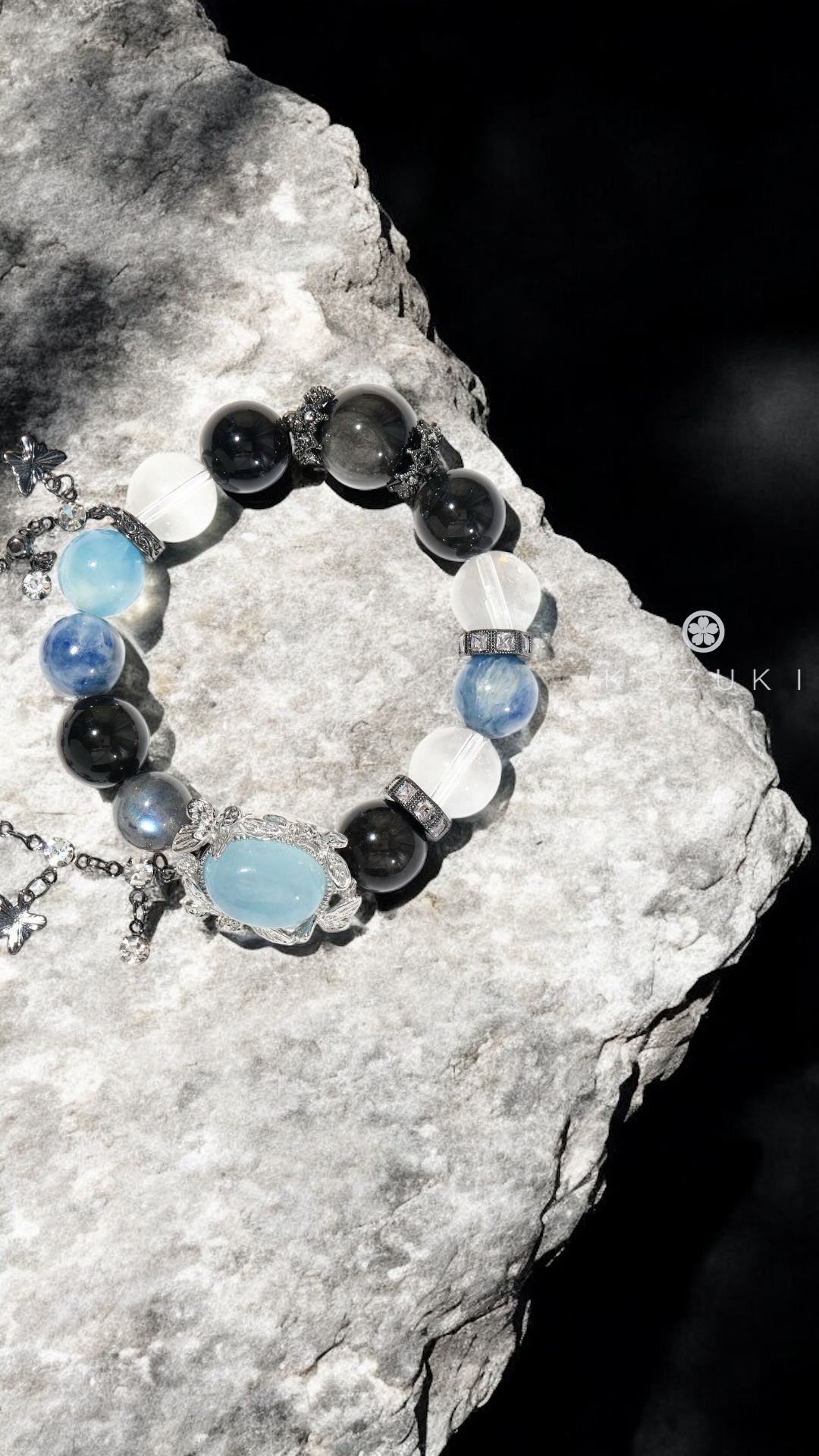 Healing crystal bracelet with aquamarine and moonstone on stone surface