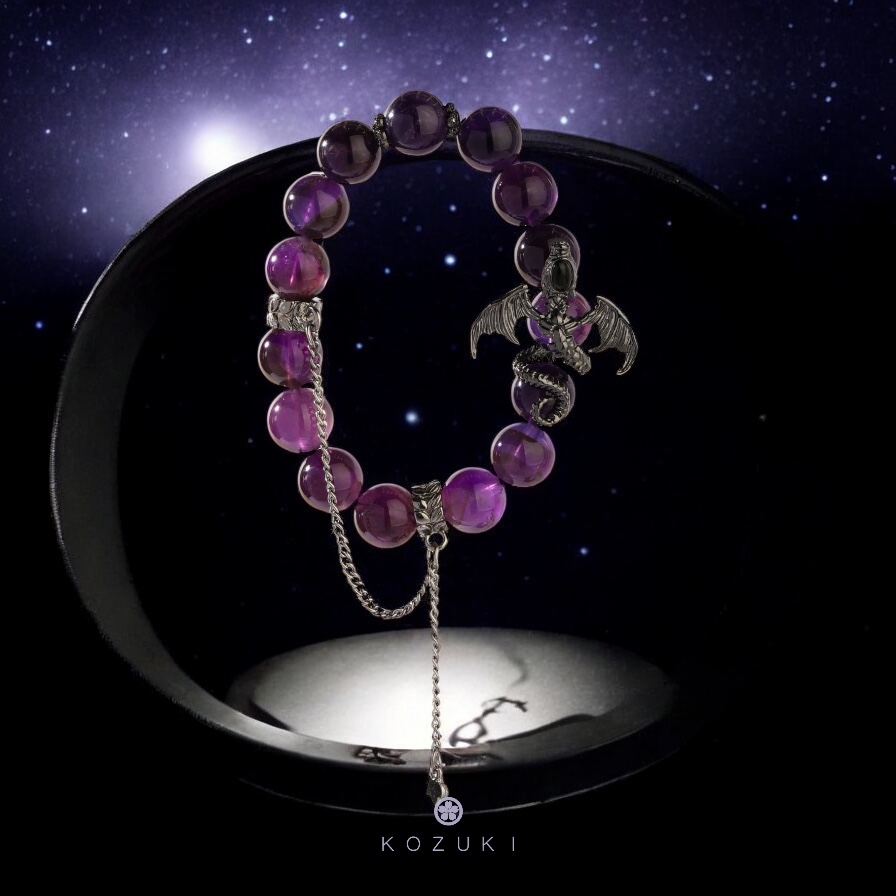 Dark purple crystal bracelet with gothic dragon charm shown against a galactic night sky