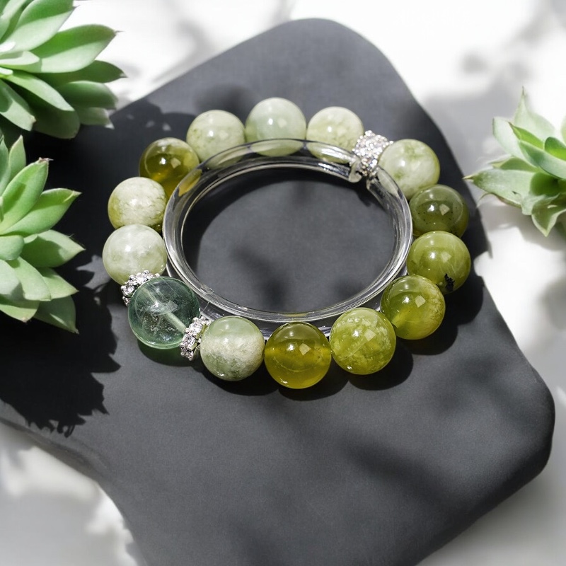 Green jade bamboo bracelet with succulents on black cushion