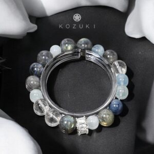 KOZUKI moonstone bracelet with sterling silver and clear quartz on white silk background
